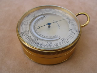 Antique pocket barometer with curved thermometer