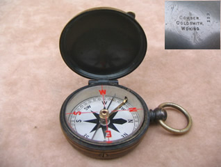 Edwardian brass cased pocket compass signed 'Comber Goldsmith Woking'
