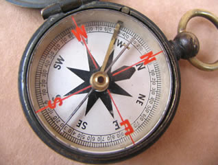 Close up view of compass dial with English cross bar needle