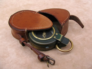 WW1 prismatic marching compass with case, both dated 1917