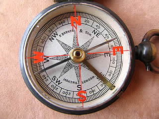 Close up view of dial showing red cardinal points