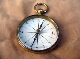 Georgian brass pocket compass with white enamel dial