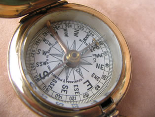 Close up view of compass dial showing makers name